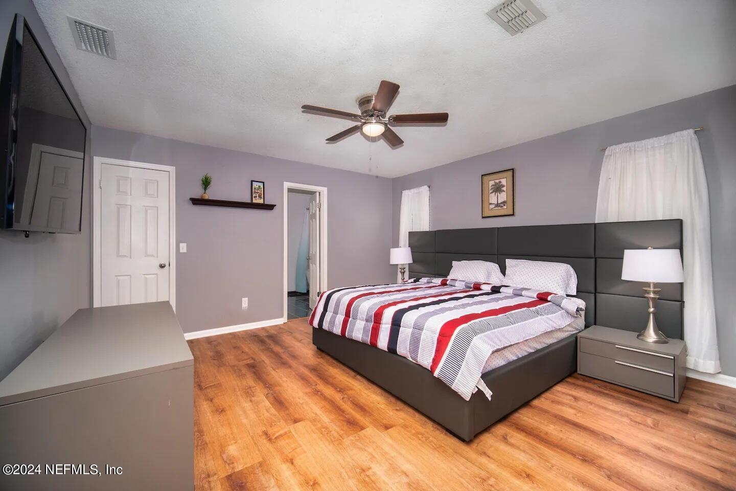 10062 Hawks Hollow Road Jacksonville, FL 32257 - Photo 28 of 39 a bedroom with a bed and a ceiling fan