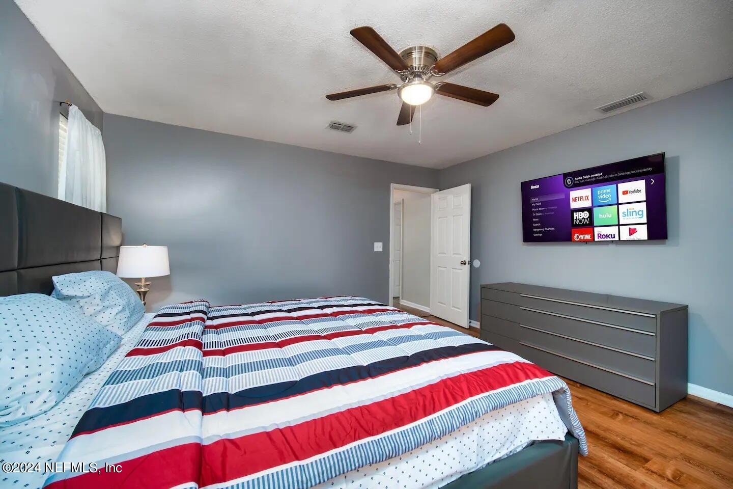 10062 Hawks Hollow Road Jacksonville, FL 32257 - Photo 29 of 39 a bedroom with a bed and a flat screen tv