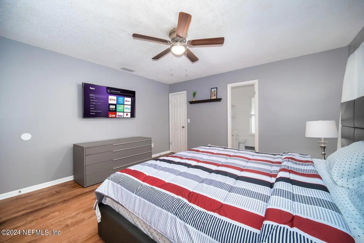 10062 Hawks Hollow Road Jacksonville, FL 32257 - Photo 30 of 39 a bedroom with a bed and a chandelier