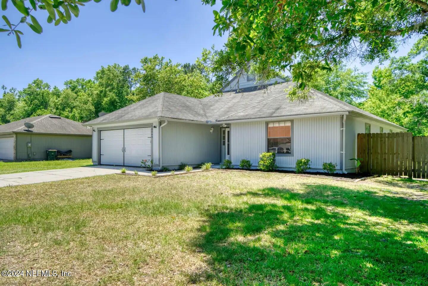 10062 Hawks Hollow Road Jacksonville, FL 32257 - Photo 35 of 39 a house with a yard and a large tree