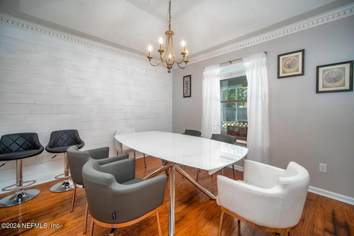10062 Hawks Hollow Road Jacksonville, FL 32257 - Photo 10 of 39 a dining room with furniture and a chandelier
