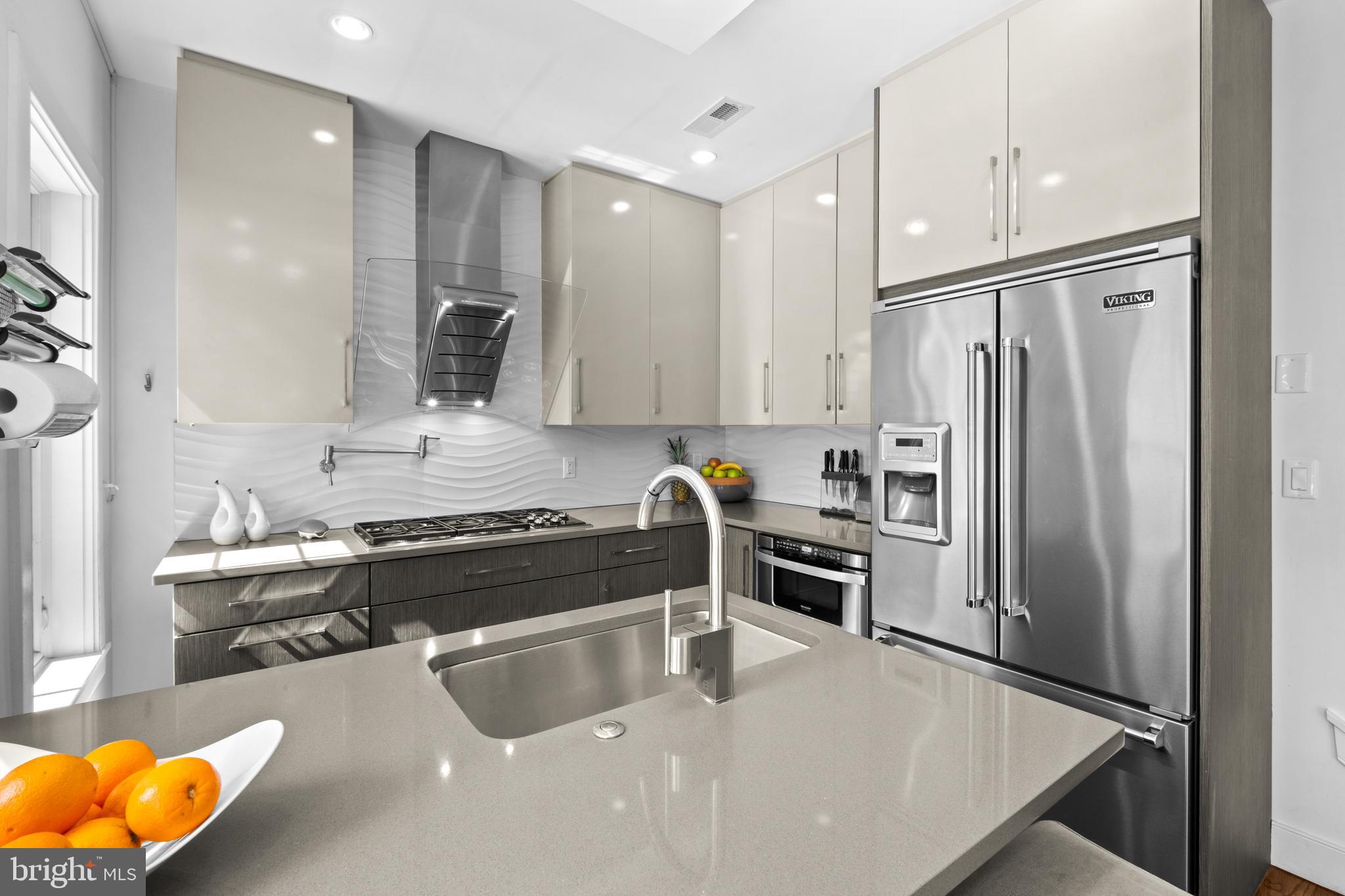 1815 Lombard Street Philadelphia, PA 19146 - Photo 25 of 79 a kitchen with stainless steel appliances granite countertop a refrigerator and a sink