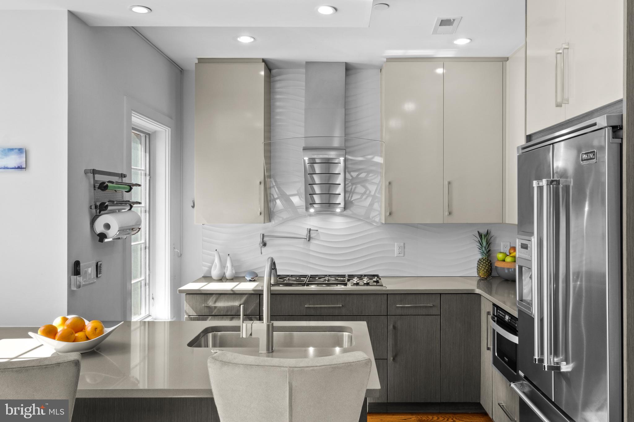 1815 Lombard Street Philadelphia, PA 19146 - Photo 27 of 79 a kitchen with stainless steel appliances granite countertop a sink and a refrigerator