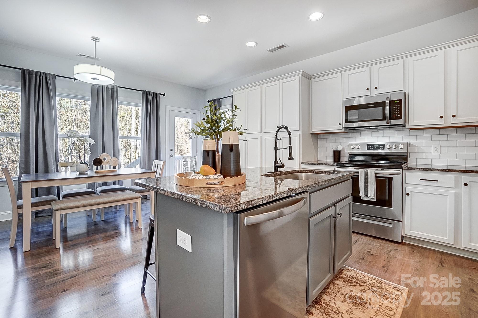 356 Nantucket Way Rock Hill, SC 29732 - Photo 6 of 34 a kitchen with stainless steel appliances granite countertop a stove a sink and a refrigerator