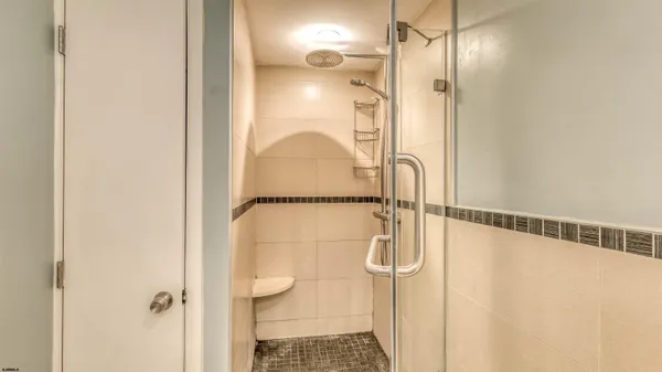 a bathroom with a glass shower door
