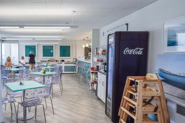 a view of a room with lots of furniture and a rug