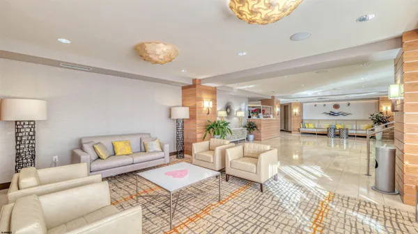 a view of a hallway with a dining area and chandelier