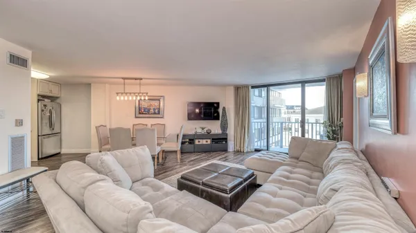 a living room with furniture large window and a flat screen tv