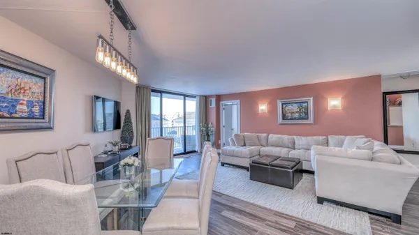 a living room with furniture and a chandelier