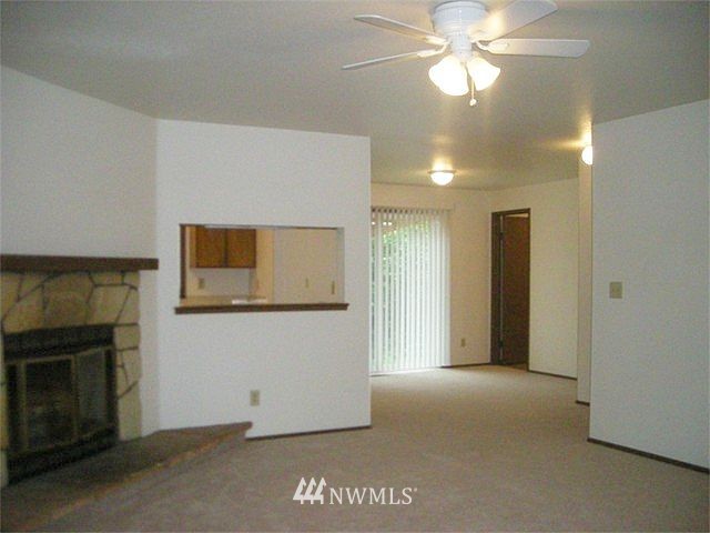10801 Southeast 170th Street Renton, WA 98055 - Photo 3 of 10 a view of a livingroom with a chandelier fan and a fireplace