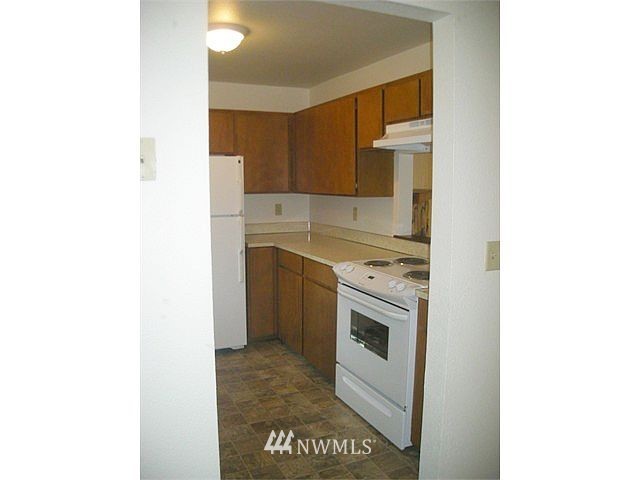 10801 Southeast 170th Street Renton, WA 98055 - Photo 6 of 10 a kitchen with a sink and a stove