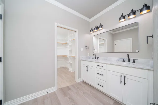 a spacious bathroom with a granite countertop sink mirror and