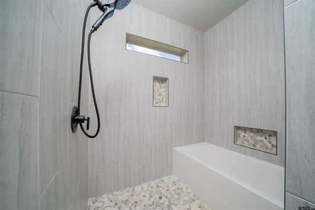 a bathroom with a bath tub and a shower