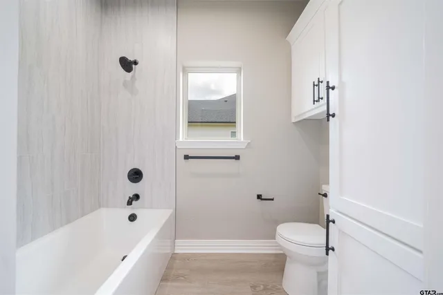 a bathroom with a toilet and a bathtub
