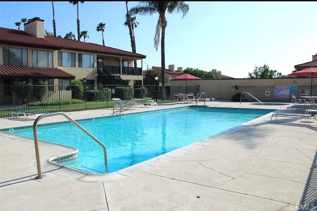 a view of a patio with swimming pool table and chairs