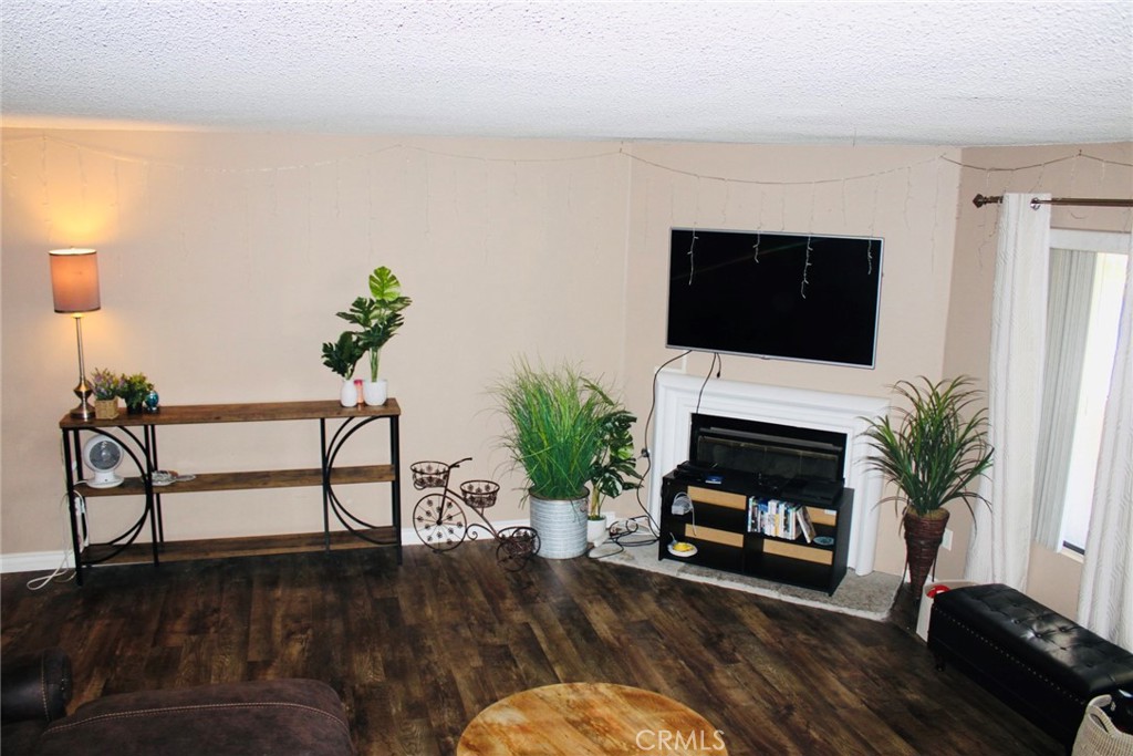 25584 Sharp Drive, Unit D Hemet, CA 92544 - Photo 4 of 9 a living room with furniture a fireplace and a potted plant