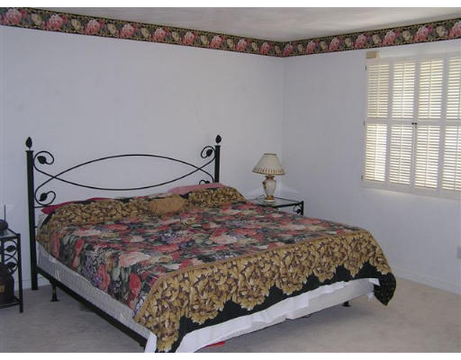 4 Colonel Gridley Road Sharon, MA 02067 - Photo 5 of 8 a bedroom with a bed window and a chandelier