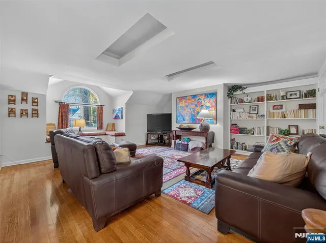 a living room with furniture ceiling fan and a rug