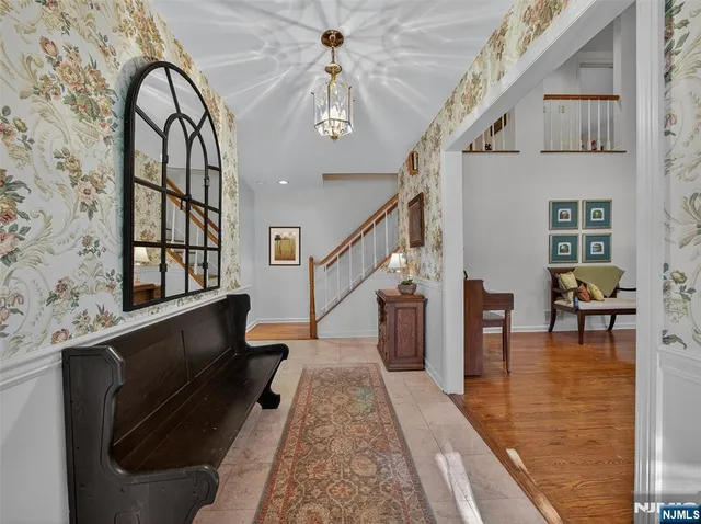 a view of entryway and hall with wooden floor