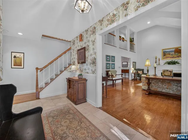 a living room with furniture and a dining table with wooden floor