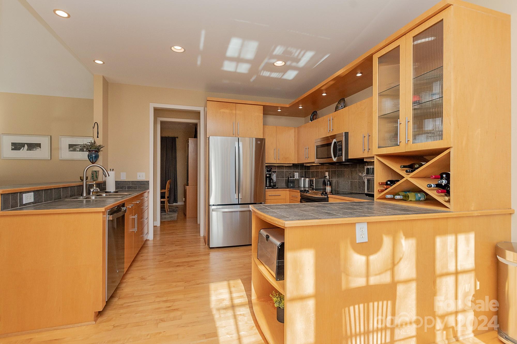 3211 Happy Hill Road Lexington, NC 27295 - Photo 16 of 44 a kitchen with stainless steel appliances granite countertop a refrigerator a stove and a sink with wooden floor
