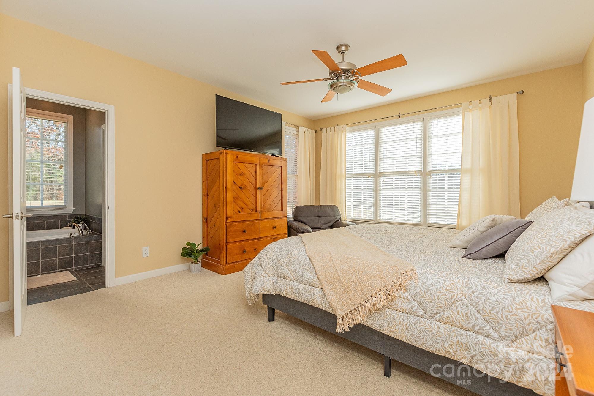 3211 Happy Hill Road Lexington, NC 27295 - Photo 22 of 44 a bedroom with a bed and a flat tv screen on dresser