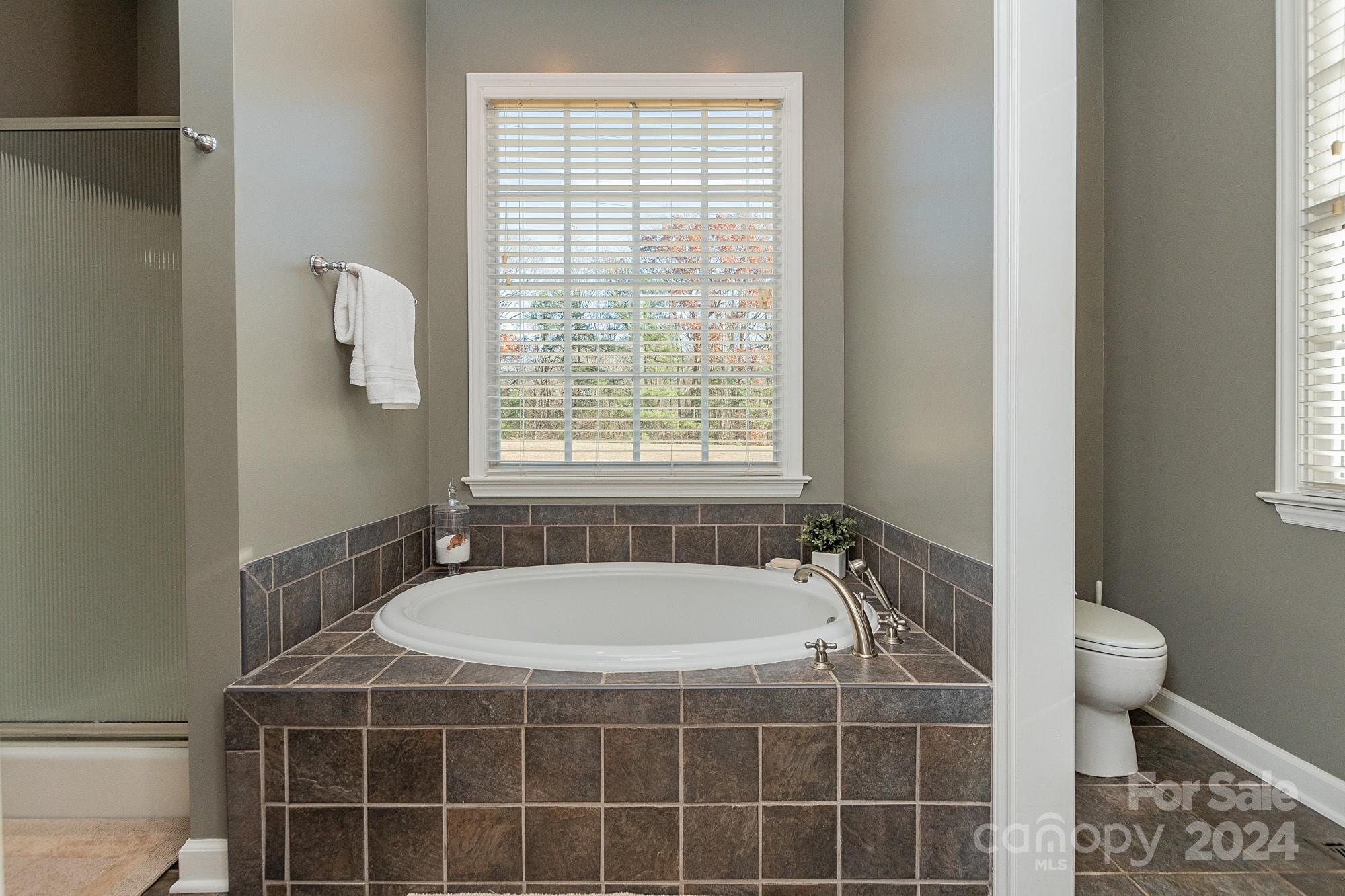3211 Happy Hill Road Lexington, NC 27295 - Photo 24 of 44 a bathroom with a tub a sink a window and a shower