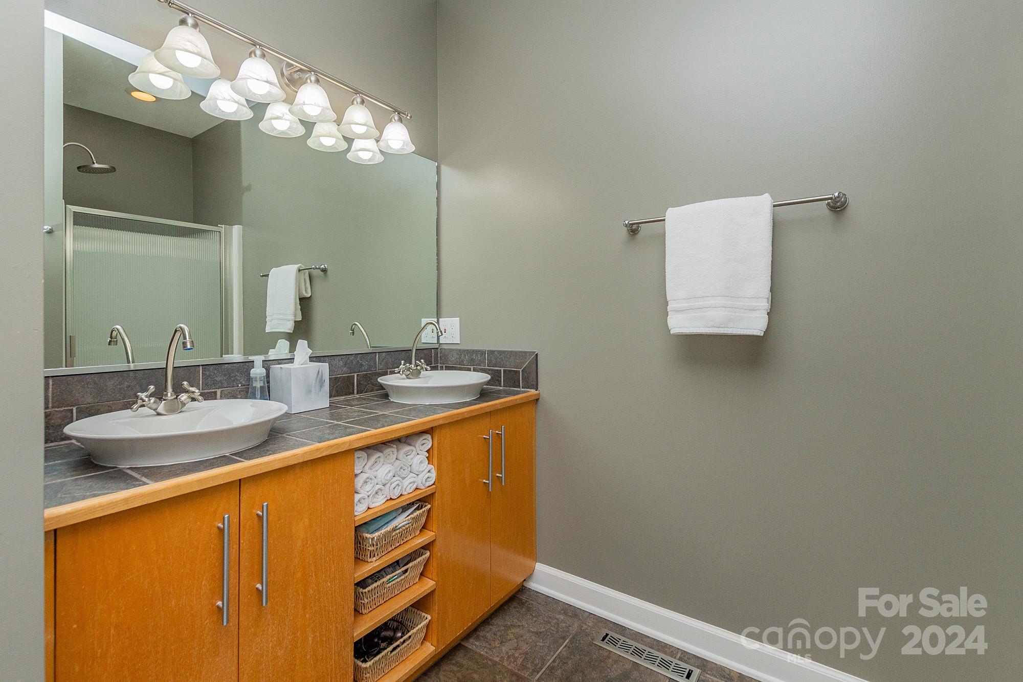 3211 Happy Hill Road Lexington, NC 27295 - Photo 25 of 44 a bathroom with a sink and a mirror