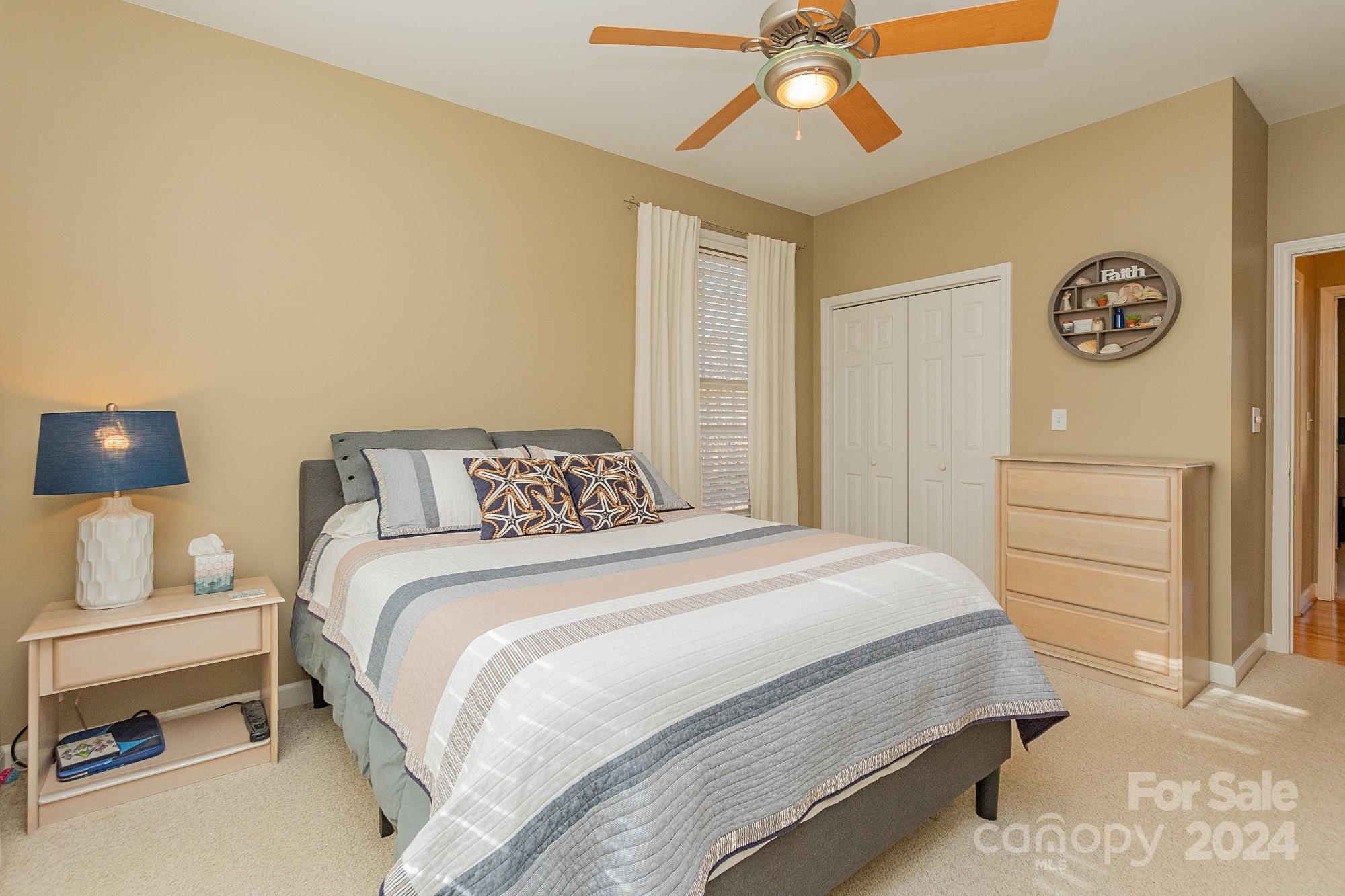 3211 Happy Hill Road Lexington, NC 27295 - Photo 30 of 44 a bedroom with a bed and a chandelier