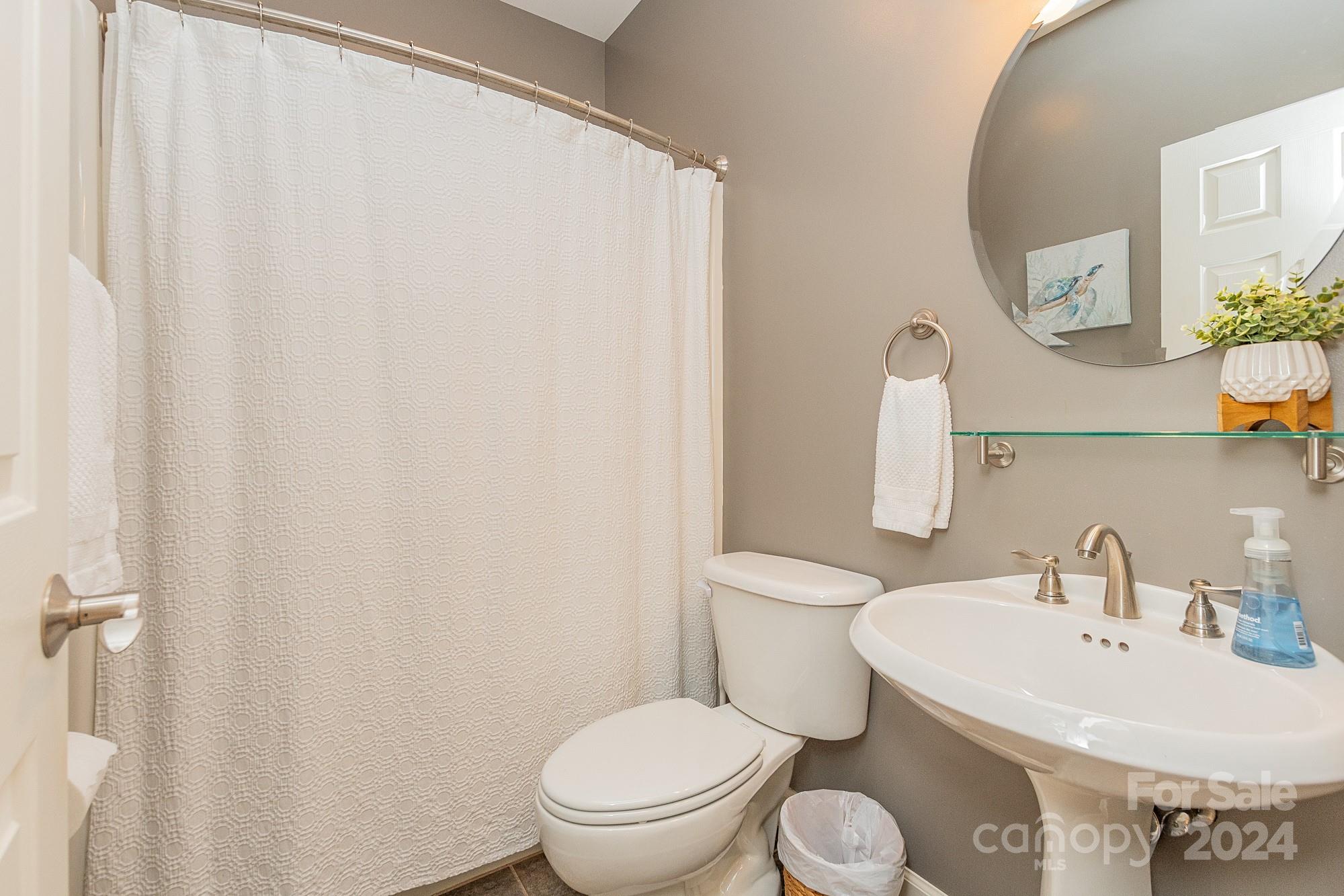 3211 Happy Hill Road Lexington, NC 27295 - Photo 31 of 44 a white toilet sitting next to a bathroom sink