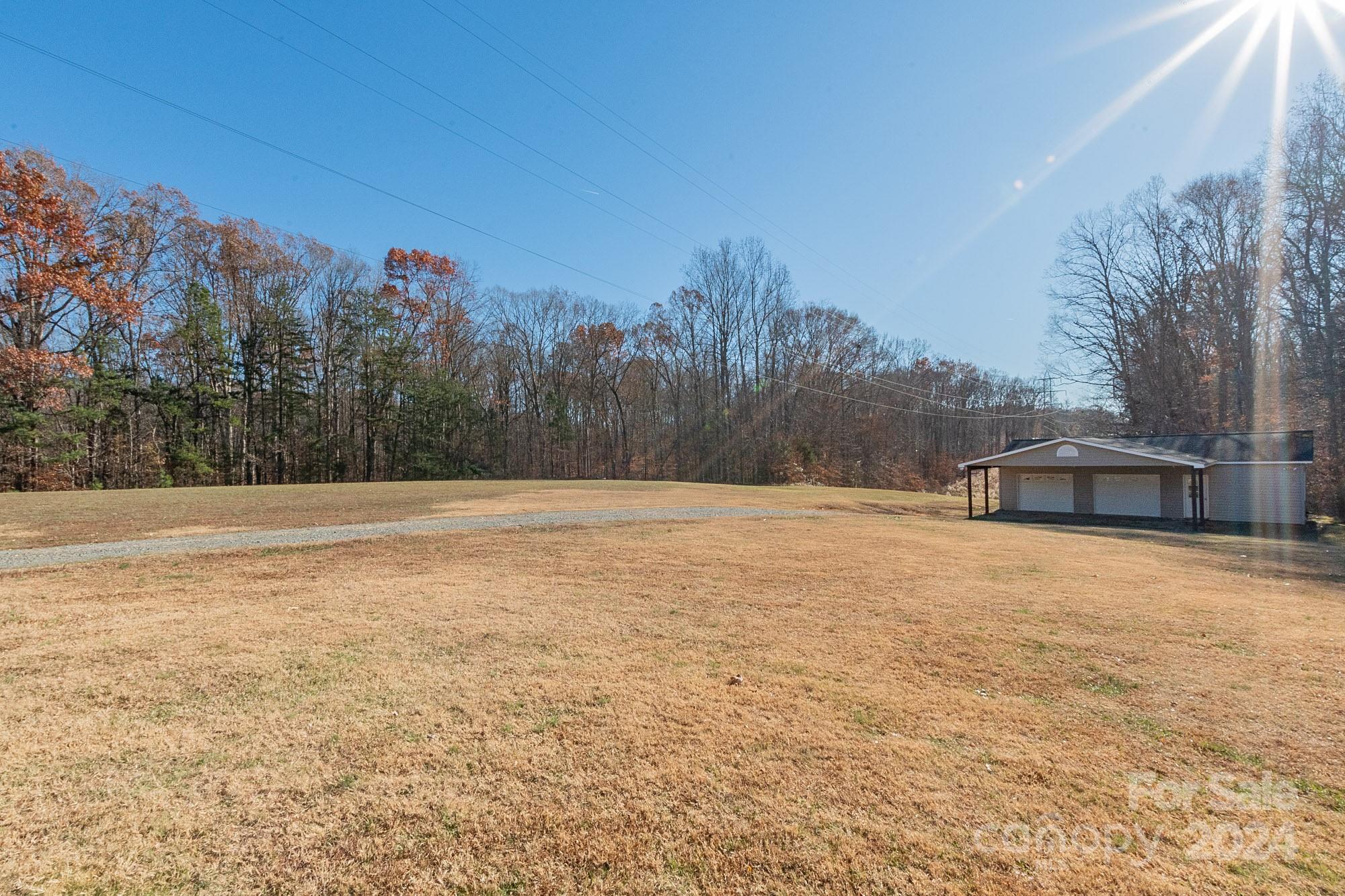 3211 Happy Hill Road Lexington, NC 27295 - Photo 43 of 44 a backyard of a house with trees