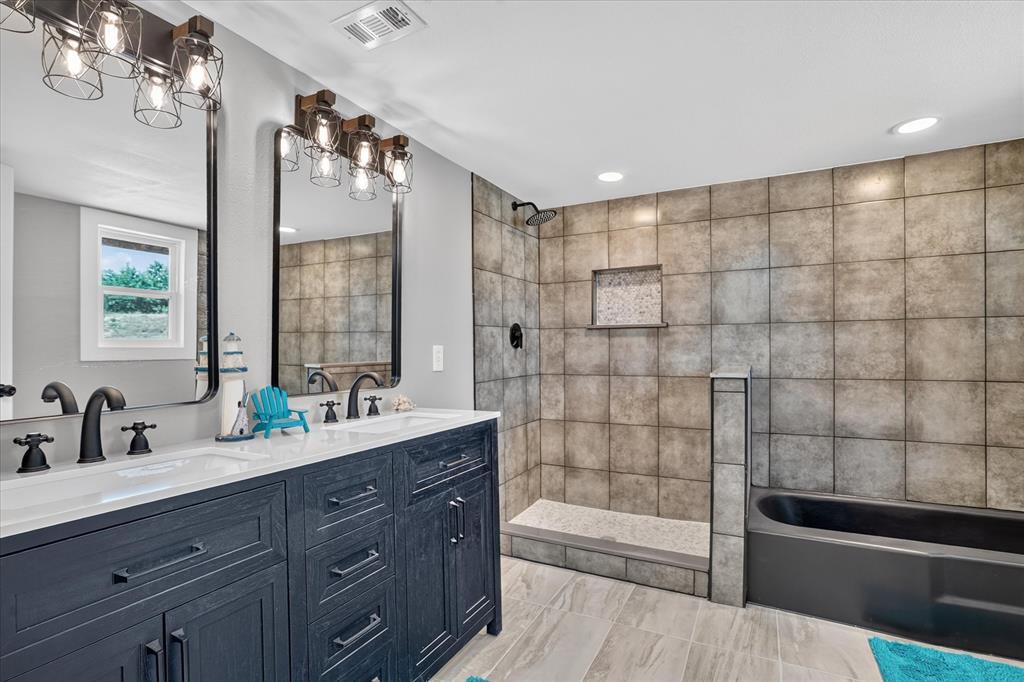 130 R And R Drive Springtown, TX 76082 - Photo 21 of 40 Dual vanity with matte black fixtures and under-sink storage