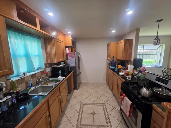 a kitchen with sink stove and cabinets