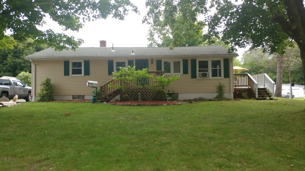185 Chudy Street Three Rivers, MA 01080 - Photo 2 of 16 a front view of house with yard and green space