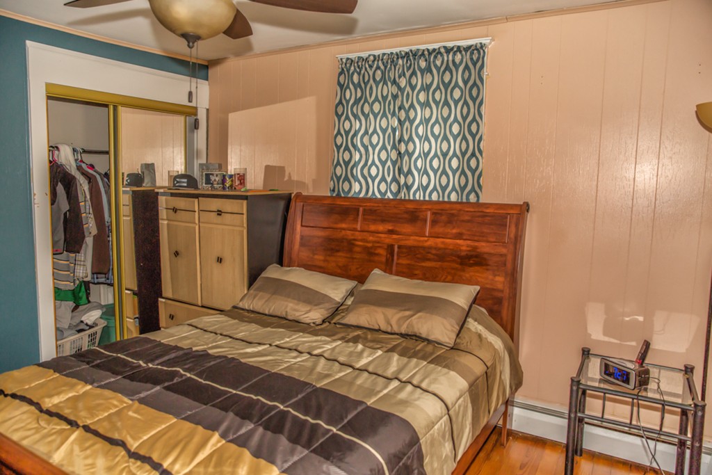 101 Daviston Street Springfield, MA 01108 - Photo 14 of 25 a bedroom with a bed a dresser and flowerpot