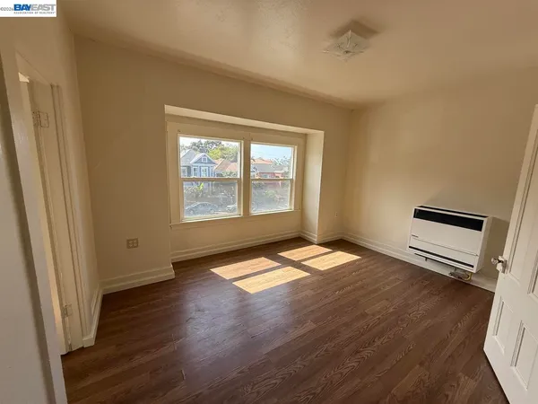 a view of a room wooden floor and staircase