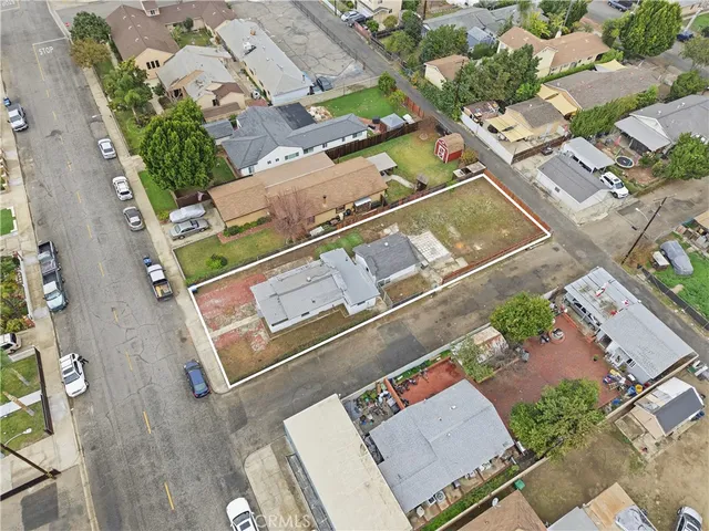 an aerial view of a house with a yard