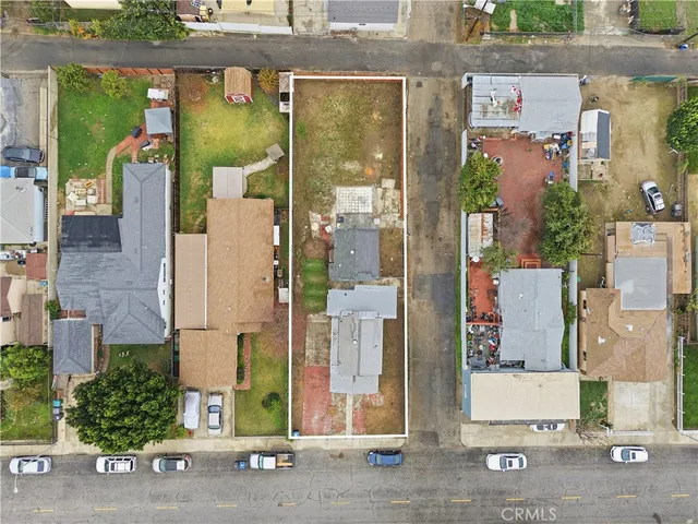 an aerial view of a house with a street