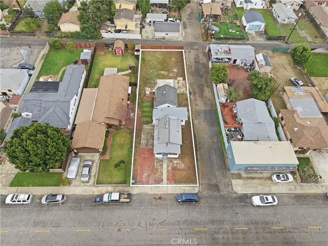 an aerial view of residential house with parking
