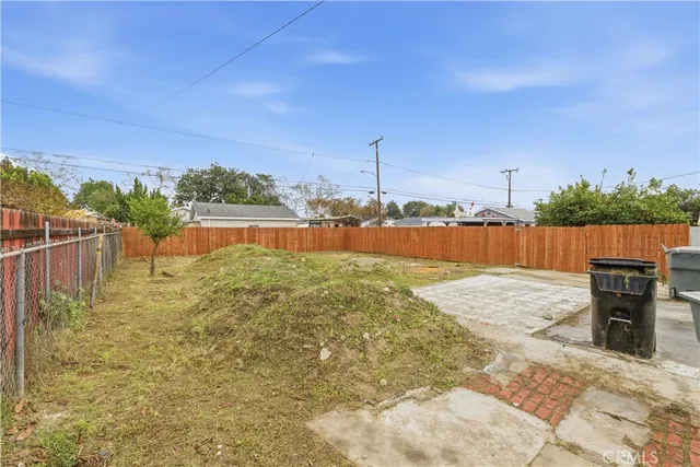 a view of a lake with wooden fence
