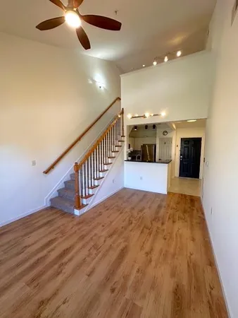 a view of entryway and hall with wooden floor