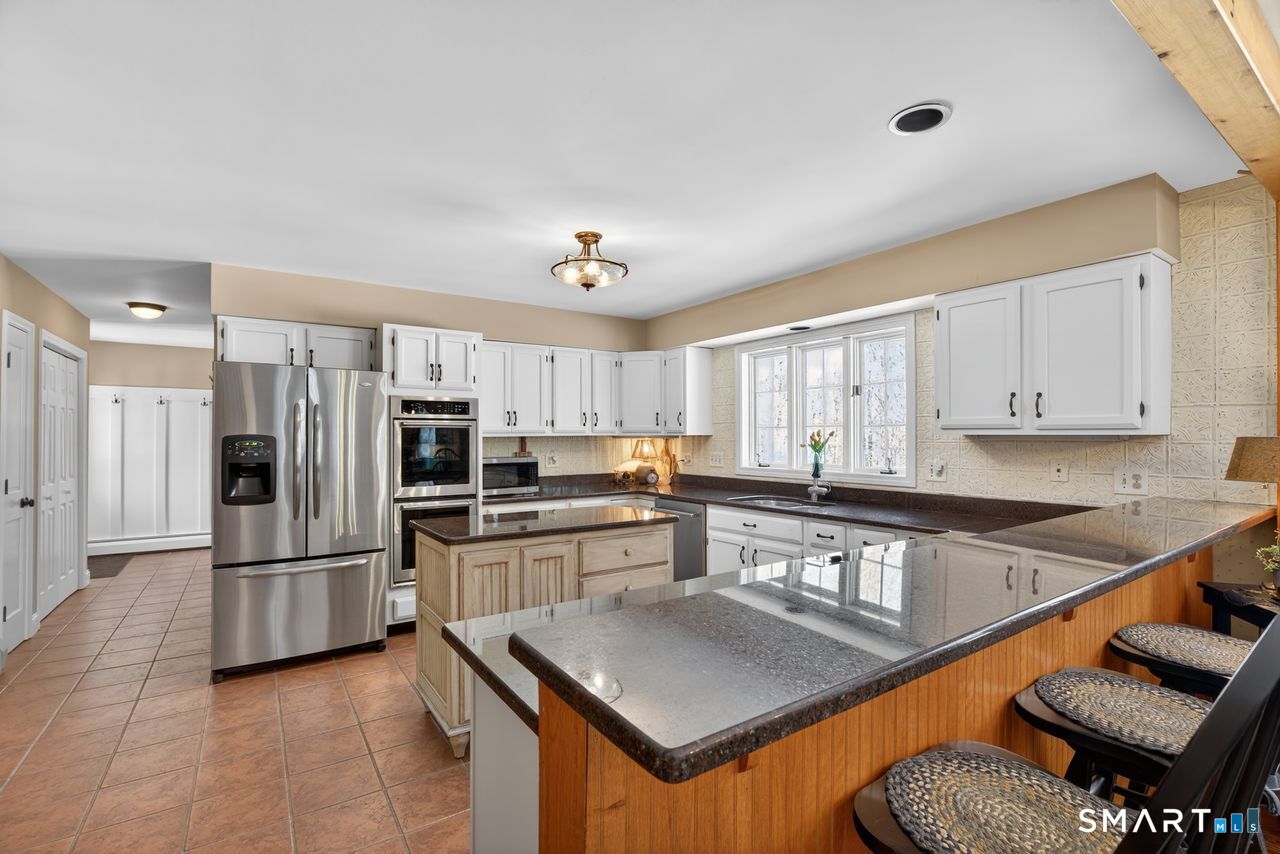 4 Hunters Ridge Road Killingworth, CT 06419 - Photo 20 of 40 a kitchen with stainless steel appliances granite countertop a refrigerator and a stove top oven