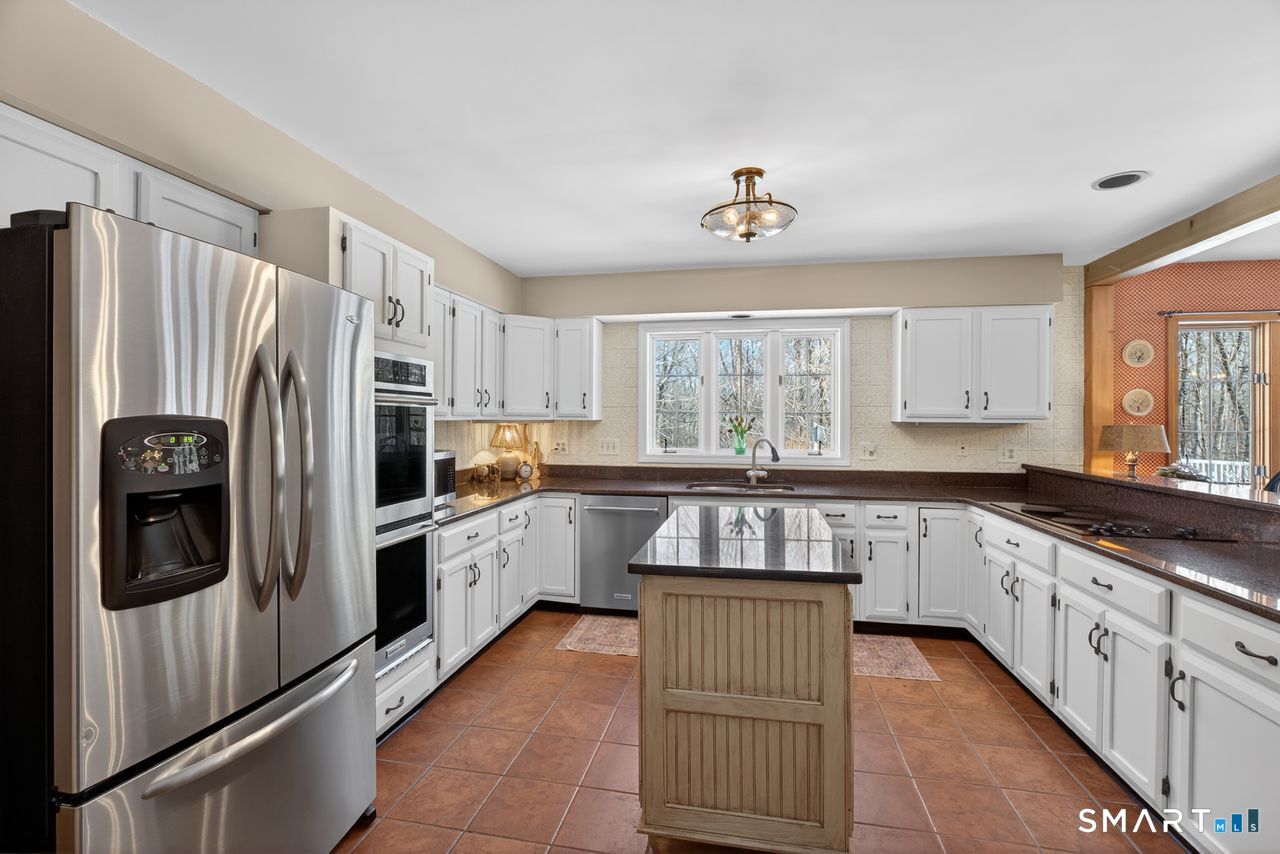 4 Hunters Ridge Road Killingworth, CT 06419 - Photo 22 of 40 a kitchen with granite countertop a refrigerator and a sink
