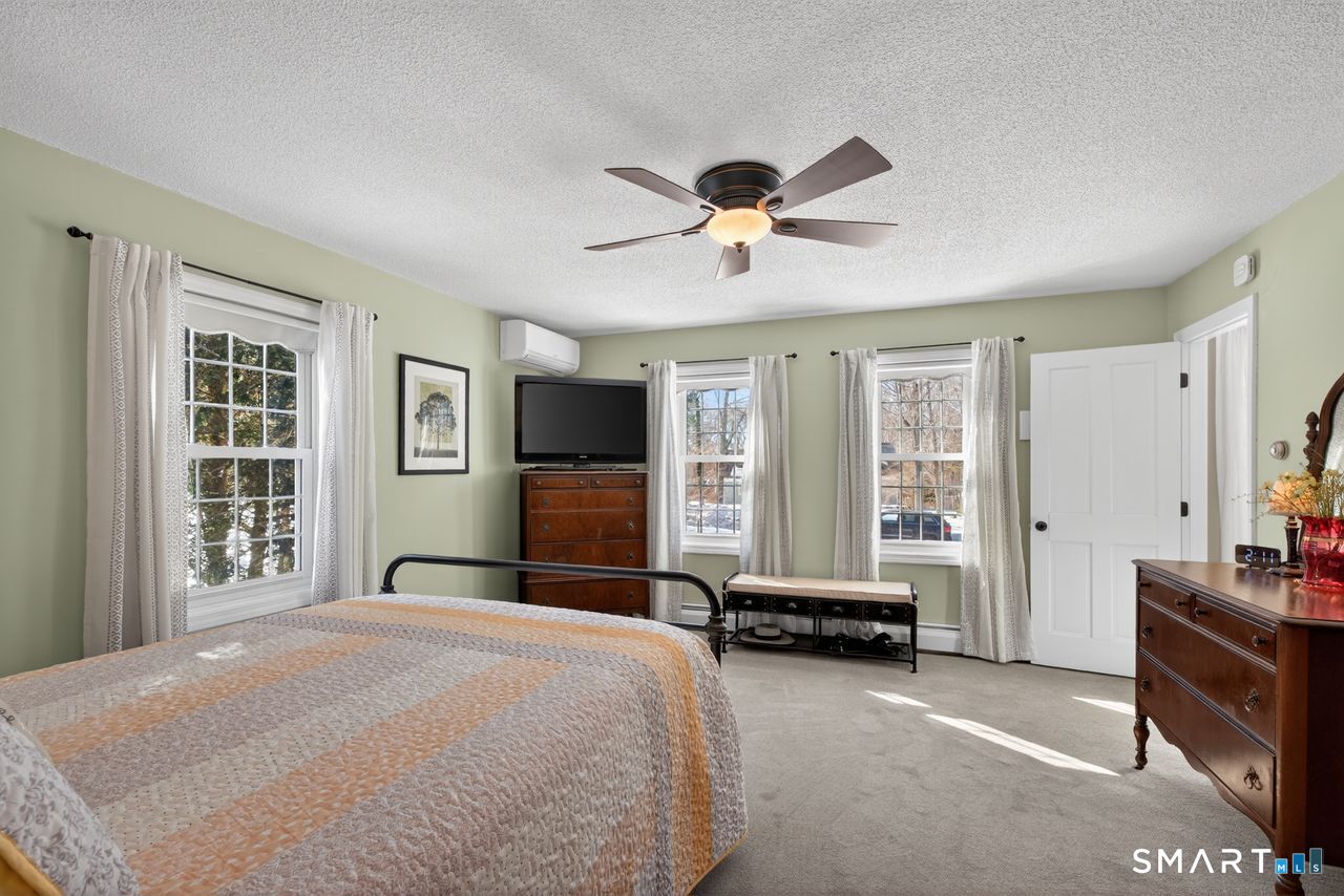 4 Hunters Ridge Road Killingworth, CT 06419 - Photo 30 of 40 a bedroom with a large bed a flat screen tv and a large window