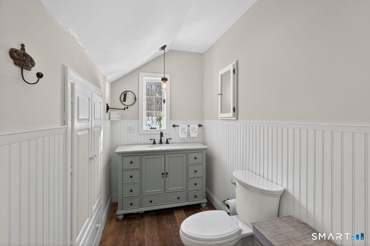 4 Hunters Ridge Road Killingworth, CT 06419 - Photo 32 of 40 a bathroom with a toilet a sink a mirror and vanity