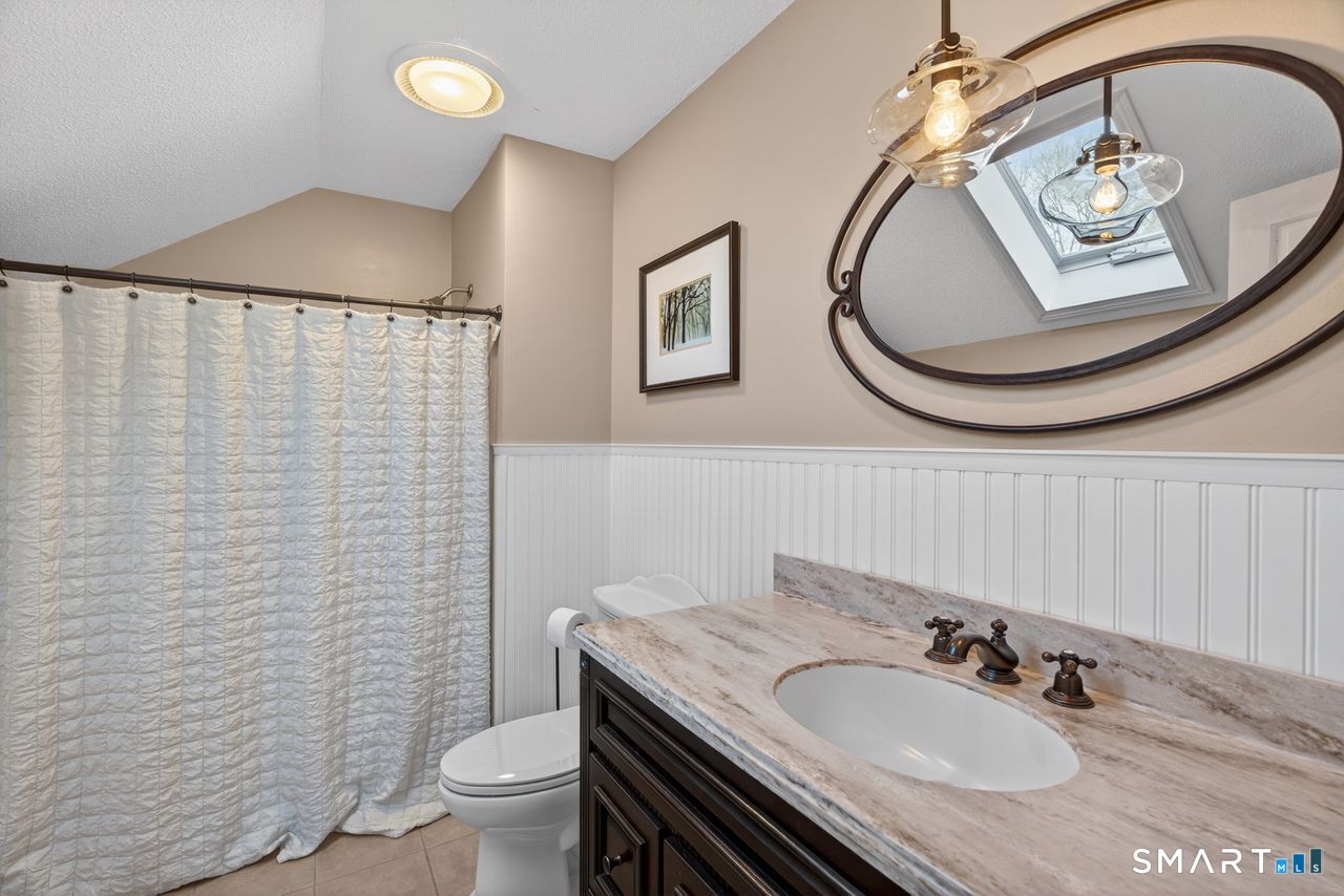 4 Hunters Ridge Road Killingworth, CT 06419 - Photo 37 of 40 a bathroom with a sink a toilet and a mirror