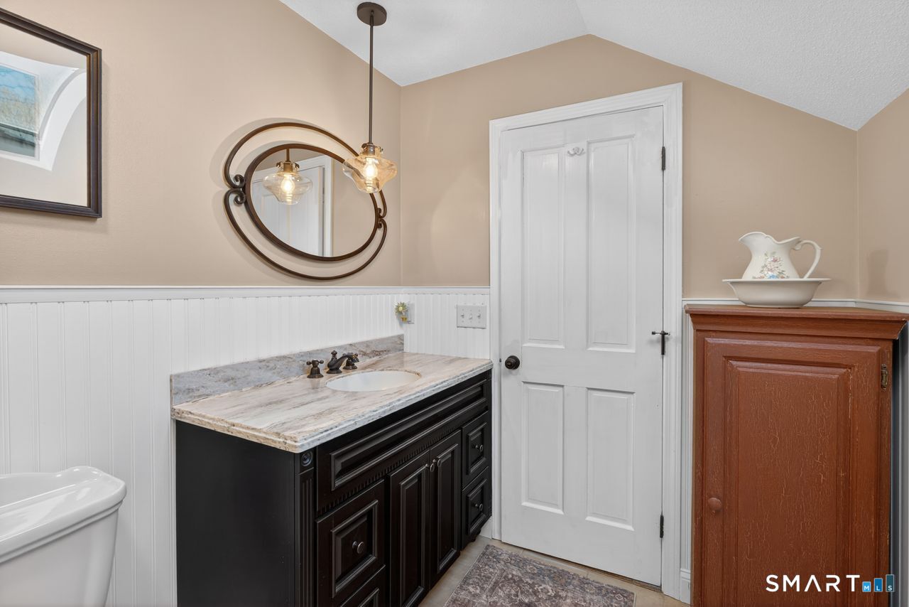4 Hunters Ridge Road Killingworth, CT 06419 - Photo 38 of 40 a bathroom with a sink a toilet and a mirror