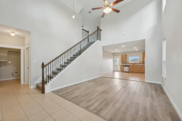 a view of a hallway view with wooden floor and staircase
