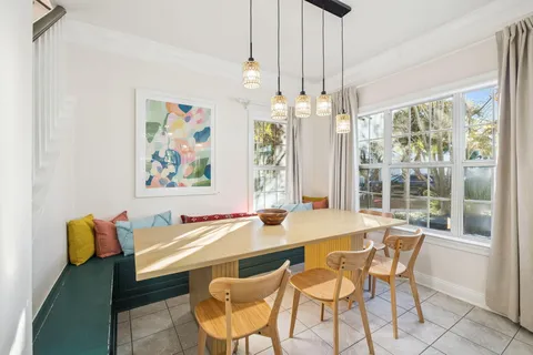 a bedroom with a bed next to a large window