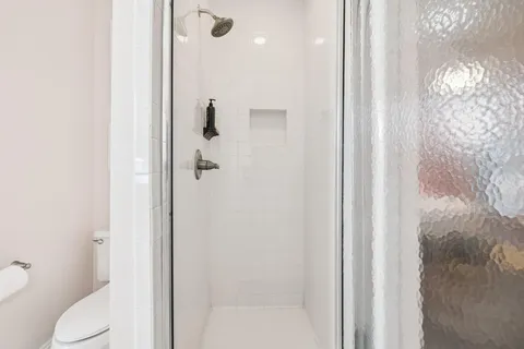 a view of a living room with a flat tv screen on dresser